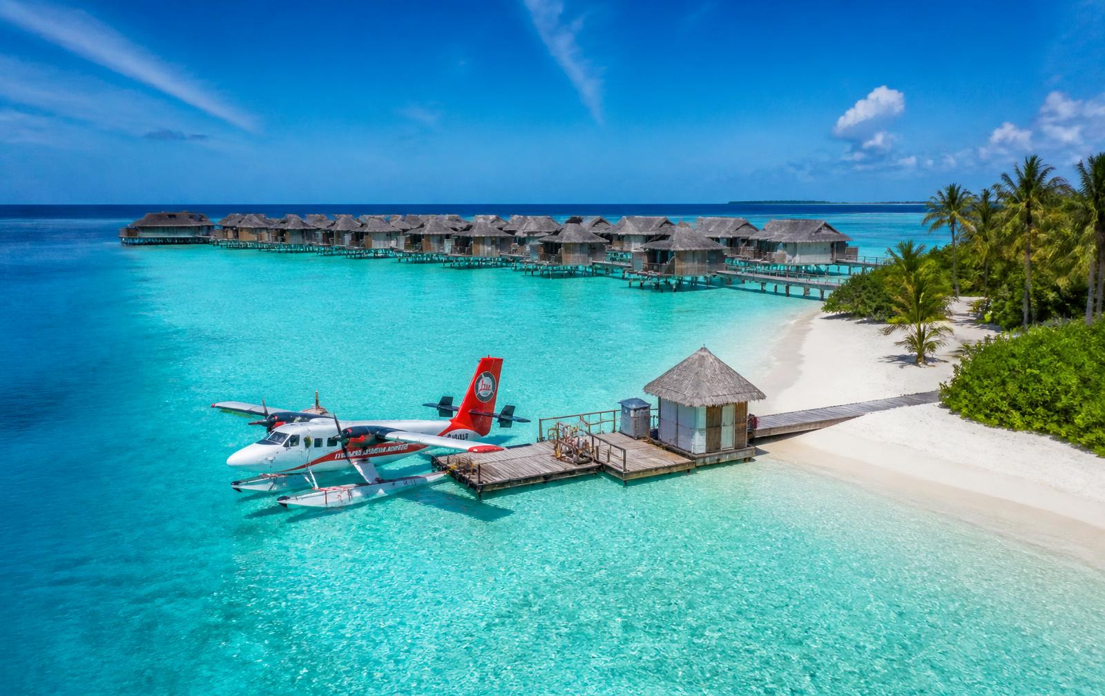 Overwater villas above turquoise lagoon in the Maldives